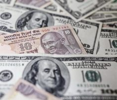 Rupee trims losses, trades flat against US dollar