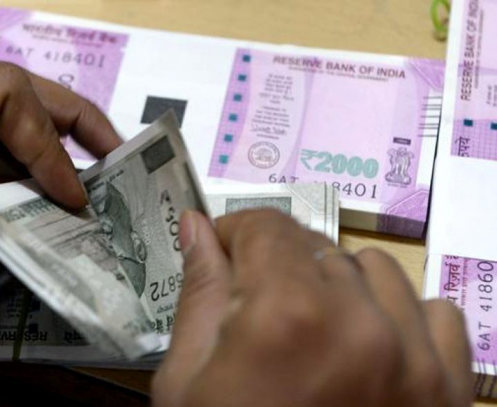 Rupee trades marginally higher against US dollar